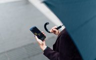 Woman with VEXI Mobile App on her phone